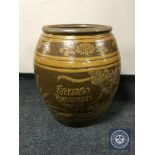 A large glazed earthenware barrel planter