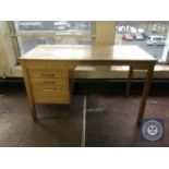 A mid twentieth century single pedestal desk fitted with three drawers