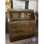 A late nineteenth century inlaid mahogany barrel fronted bureau