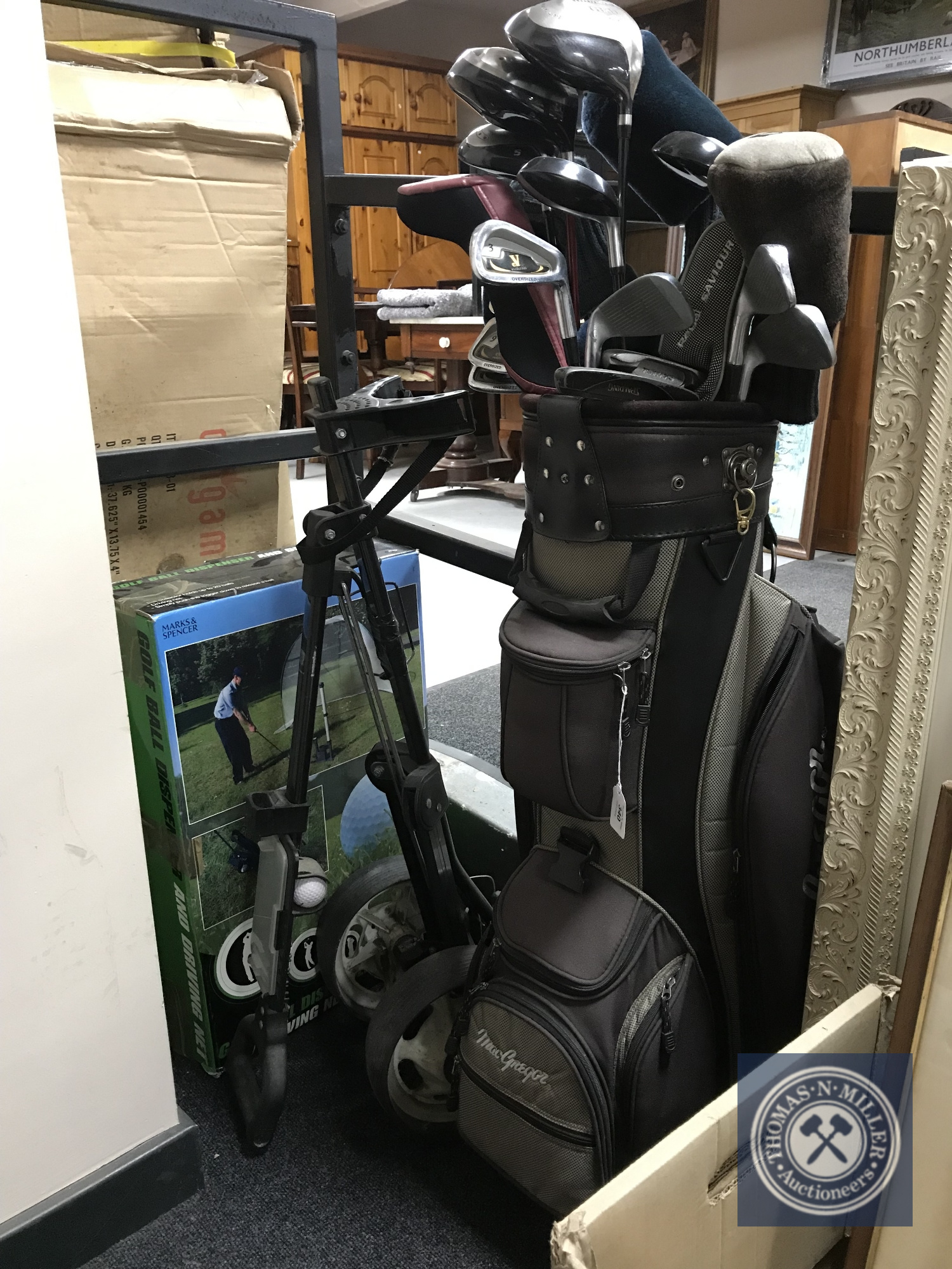 A McGregor golf bag containing golf drivers, irons,