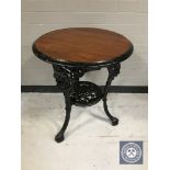 A circular Britannia pub table on cast iron base