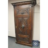 A 19th century carved oak single door cabinet,