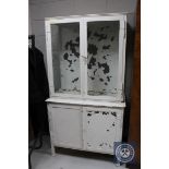 A mid 20th century metal glazed door medical cabinet,