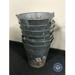 Six galvanised metal buckets.