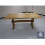 A blonde oak refectory dining table