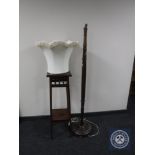 An early twentieth century mahogany plant stand together with standard lamp and shade