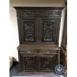 A 19th century continental profusely carved oak cabinet fitted with drawers