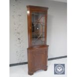 A mahogany corner display cabinet