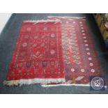 Two Eastern fringed rugs on red ground