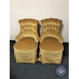 A pair of early 20th century nursing chairs upholstered in golden buttoned dralon