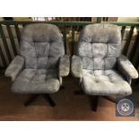A pair of upholstered swivel armchairs