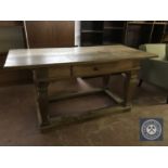 An early twentieth century continental oak library table fitted a drawer