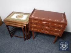 A nest of three Danish teak tiled tables together with a hand painted three drawer bedside chest