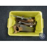 A box containing vintage hand tools