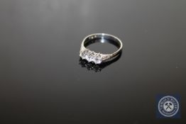 A platinum three stone diamond ring,