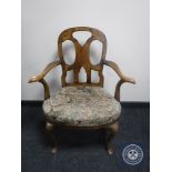 A Victorian walnut tapestry upholstered armchair on cabriole legs