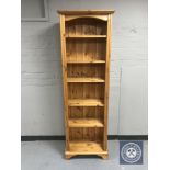 A set of narrow pine bookshelves