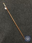 A swagger stick with 18ct gold plated and enamel mount