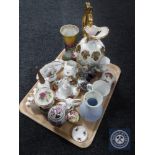 A tray of decorative china ornaments, ornamental egg on stand,