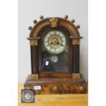 An American beech cased mantel clock with enamelled dial