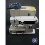 A cased Dorina 75 electric sewing machine (continental wired)