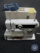 A cased Dorina 75 electric sewing machine (continental wired)