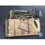 A box of antique stirrup pumps and four vintage tennis rackets