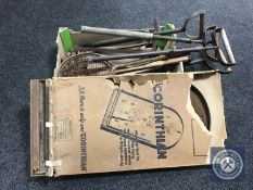 A box of antique stirrup pumps and four vintage tennis rackets