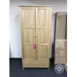 A boxed Bentley Designed oak double door wardrobe fitted a drawer