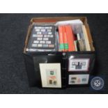 A box containing a large quantity of stamps and stamp reference books