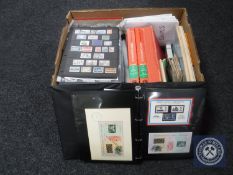 A box containing a large quantity of stamps and stamp reference books