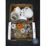 Two boxes of vintage oil lamp parts, glass shades etc.