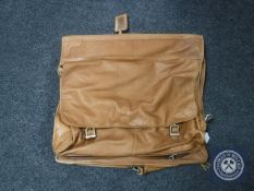 A tan leather suit carrying case