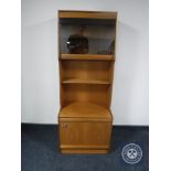 A mid 20th century teak S-Form display unit fitted cupboards beneath