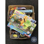 Two boxes of assorted toys including die cast vehicles, Thomas the Tank Engine rails, postcards,