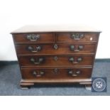 A George III mahogany five drawer chest with brass drop handles on bracket feet