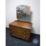 An oak dressing chest fitted three drawers