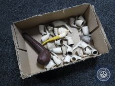 A box of assorted clay pipes