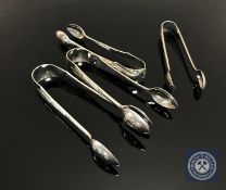 Four sets of silver sugar tongs