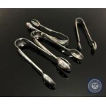 Four sets of silver sugar tongs