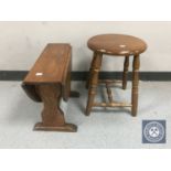 A small oak drop leaf occasional table together with a stool