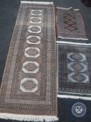 A runner and two other rugs CONDITION REPORT: The runner is 241cm long and 80cm