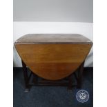 An Edwardian mahogany gate leg table