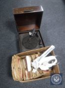 An early 20th century mahogany cased table top record player together with a box containing 78