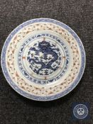 A Chinese celadon glazed porcelain plate depicting a five-clawed dragon,