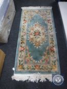 A fringed Chinese rug CONDITION REPORT: 175cm by 77cm.