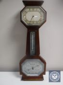 A mahogany barometer with silvered dial,