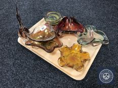 A tray containing six mid 20th century coloured glass bowls together with a glass fish ornament