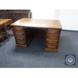 An early twentieth century oak twin pedestal desk