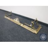 An early 20th century brass extending fire curb together with a brass jug